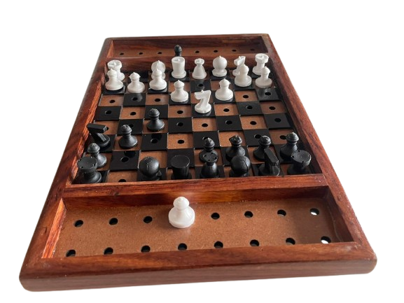 The image shows a chess set designed for blind players. The chessboard has a wooden frame and the squares are raised, likely to help players feel the board. The chess pieces are in two colors, light and dark, and are placed on the board. Next to the chessboard, there is a closed box,for storing the pieces