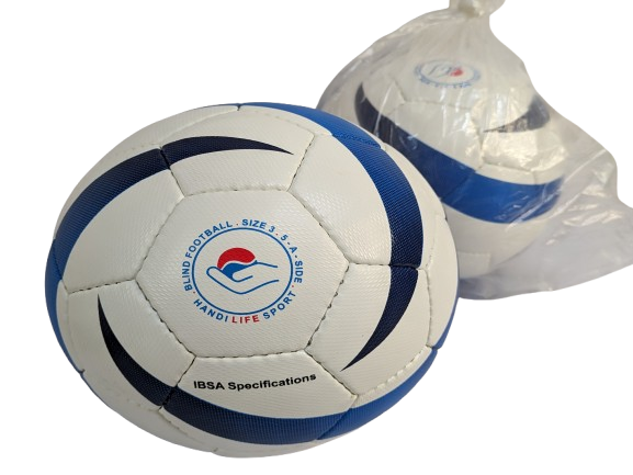 The image shows a football designed for blind football. The ball is predominantly white with blue and black curved patterns. In the center, there is a logo featuring a stylized hand holding a red circle, surrounded by text. The text reads "BLIND FOOTBALL SIZE 3.5" and "IBSA Specification" along with "INDI LIFE SPORT". Next to the ball, there is another similar ball wrapped in a transparent plastic bag. At the bottom of the image, there are green buttons labeled